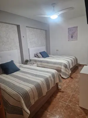two beds sitting in a room with at Habitaciones Zoe in Puerto de Sagunto