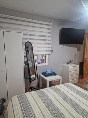 a bedroom with a bed and a dresser and a mirror at Habitaciones Zoe in Puerto de Sagunto
