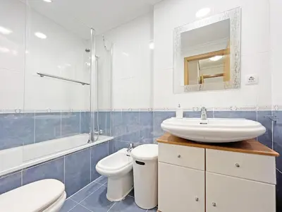 a white bathroom with a sink and a toilet at Global Vacacional, Apartamento con gran terraza en Canet in Canet de Berenguer