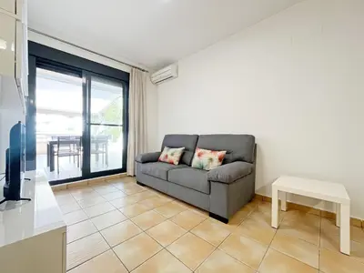 a living room with a couch and a table at Global Vacacional, Apartamento con gran terraza en Canet in Canet de Berenguer