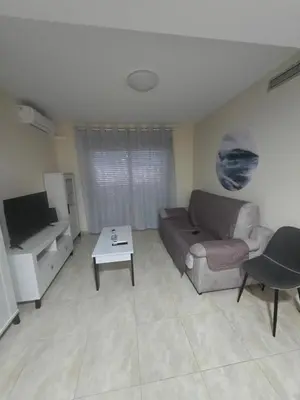 a living room with a couch and a table at Las Jarcias 3A in Moncófar