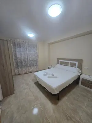 a bedroom with a large white bed in it at Las Jarcias 3A in Moncófar