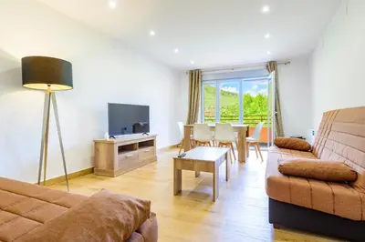 a living room with a couch and a table at Un endroit accueillant avec vue à Jerica in Jérica