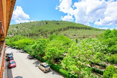 a street with cars parked on the side of a mountain at Un endroit accueillant avec vue à Jerica in Jérica