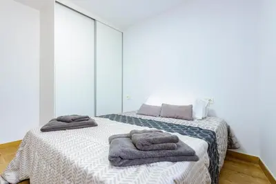 a bedroom with a bed with towels on it at Un endroit accueillant avec vue à Jerica in Jérica