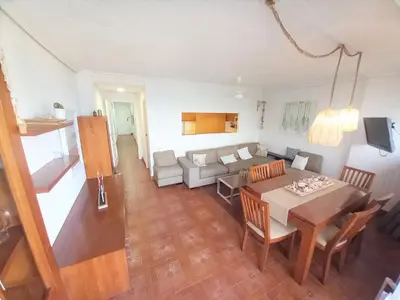 a living room with a table and a couch at Faromar, I-10-M in Cullera
