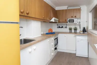 a kitchen with white cabinets and a sink at Faromar, I-10-M in Cullera