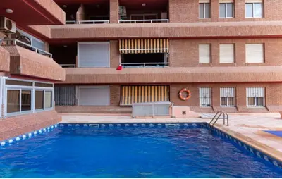 a swimming pool in front of a building at Faromar, I-10-M in Cullera