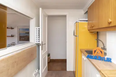 a kitchen with a yellow refrigerator and a sink at Faromar, I-10-M in Cullera