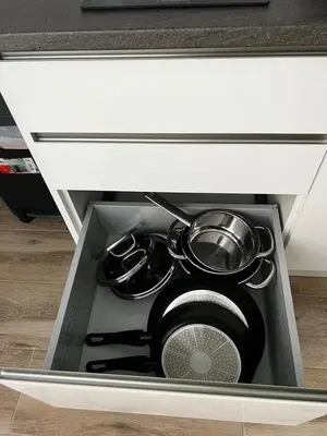 a drawer in a cabinet with pots and pans in it at Rodrigues 15 in Valencia
