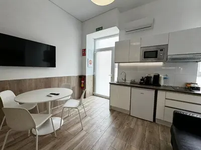 a kitchen with a white table and a table and chairs at Rodrigues 15 in Valencia