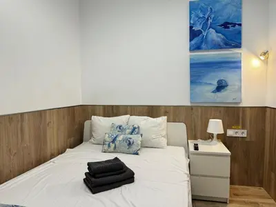 a bed with white sheets and pillows on it at Rodrigues 15 in Valencia