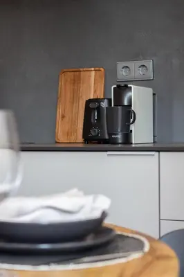 a table with a plate and cups on a counter at VLC HOST - Cubells in Valencia
