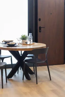 a wooden table with two chairs and a wooden door at VLC HOST - Cubells in Valencia