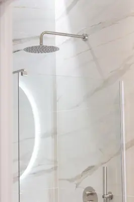a shower with a glass door and a shower head at VLC HOST - Cubells in Valencia