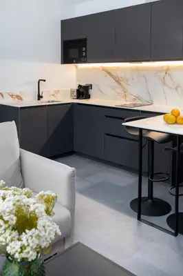 a kitchen with a sink and a counter with a table at Calatrava by Alma Suites in Valencia