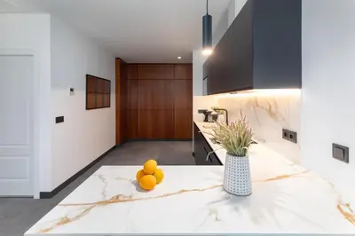 a kitchen with a counter top with oranges on it at Calatrava by Alma Suites in Valencia