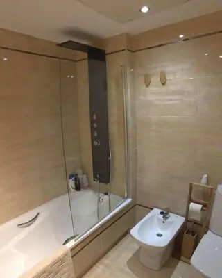 a bathroom with a tub and a sink and a toilet at Valencia Ático playa Patacona. Parking incluido in Valencia