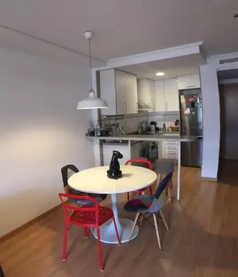 a kitchen with a table and chairs and a kitchen with a kitchen at Valencia Ático playa Patacona. Parking incluido in Valencia