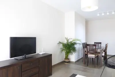a living room with a flat screen tv on a dresser at Coqueto apartamento de 3 habitaciones by Hometels in Puerto de Sagunto