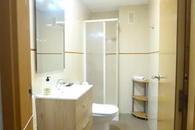 a bathroom with a toilet and a sink and a shower at Coqueto apartamento de 3 habitaciones by Hometels in Puerto de Sagunto