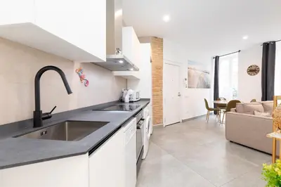 a kitchen and living room with a sink and a couch at Belmar Apartments in Valencia