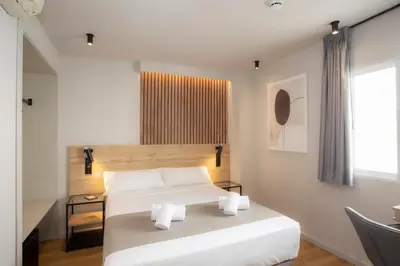a bedroom with a white bed and a window at Aila II Hotel Boutique by SingularStays - Digital Access in Burjasot