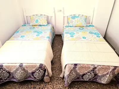 two beds sitting next to each other in a room at Piso amplio de 3 habitaciones, calefacción, ascensor y parking in Burriana