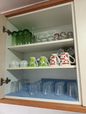a cupboard filled with lots of cups and mugs at Piso amplio de 3 habitaciones, calefacción, ascensor y parking in Burriana