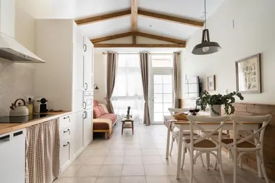 a kitchen and dining room with a table and chairs at Le Provençal de COUP DE COEUR APPARTEMENTS in Valencia