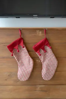 three red and white socks hanging from a stove at Le Provençal de COUP DE COEUR APPARTEMENTS in Valencia