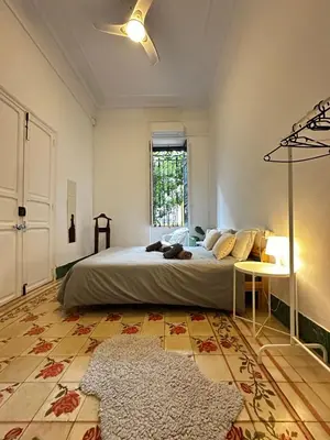 a bedroom with a large bed and a rug at Habitación con Baño privado 1 cama de matrimonio in Valencia