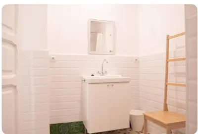 a white bathroom with a sink and a mirror at Habitación con Baño privado 1 cama de matrimonio in Valencia
