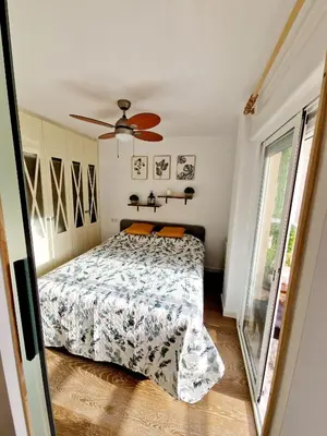 a bedroom with a bed and a ceiling fan at Cozy Rustic Home in Playa Pobla de Farnals