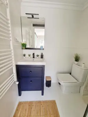 a bathroom with a toilet and a sink and a mirror at Cozy Rustic Home in Playa Pobla de Farnals