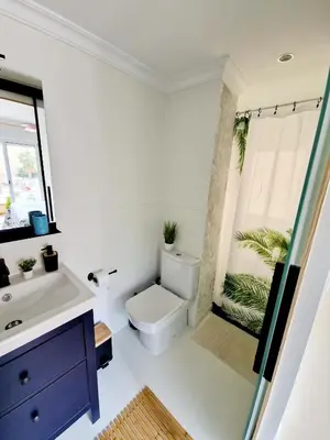 a bathroom with a toilet and a sink at Cozy Rustic Home in Playa Pobla de Farnals