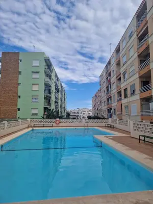 a large swimming pool in a building with buildings at Cozy Rustic Home in Playa Pobla de Farnals