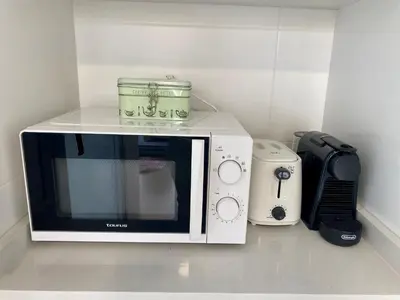 a microwave sitting on top of a kitchen counter at VerdeMar 5 (Playa Puerto de Sagunto) in Puerto de Sagunto