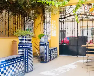 two blue and white vases sitting in front of a building at Habitación doble en Ruzafa con baño privado in Valencia