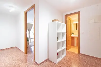 a white closet in a room with a mirror at Global Vacacional, Apartamento de 3 dormitorios en Sagunto in Sagunto