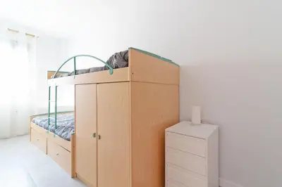 a bedroom with a bunk bed and a cabinet at Global Vacacional, Apartamento con gran terraza en la playa de Canet in Canet de Berenguer