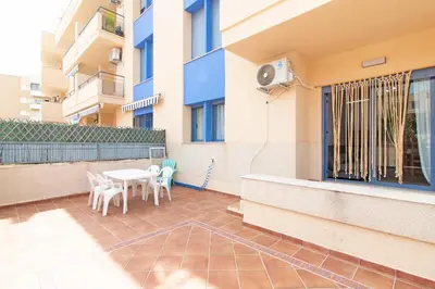 a balcony with a table and chairs in a building at Global Vacacional, Apartamento con gran terraza en la playa de Canet in Canet de Berenguer