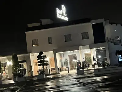 a building with a sign on top of it at night at DON LEONE Hotel in Alginet