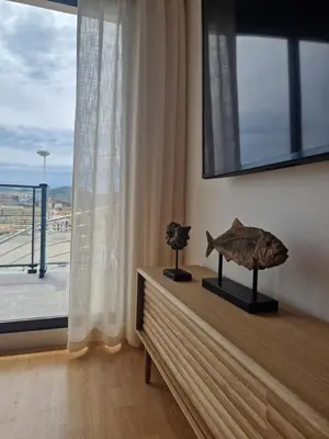 a room with a large window and a fish on a table at Casa Buena Vista con piscina y ascensor in Cullera