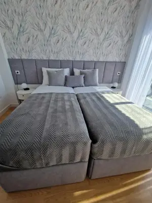 a large bed in a bedroom with a wall at Casa Buena Vista con piscina y ascensor in Cullera