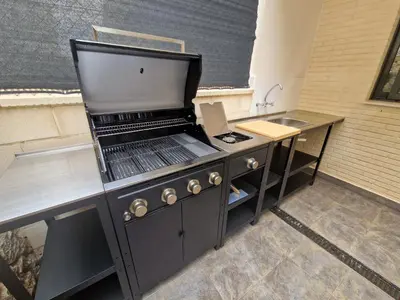 a kitchen with a stove and a sink at Casa Buena Vista con piscina y ascensor in Cullera