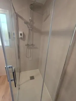 a bathroom with a shower with a glass door at Chalet El Tochar in Valencia