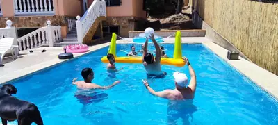 a group of people playing in a swimming pool at Chalet El Tochar in Valencia