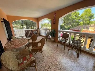 a room with a balcony with a table and chairs at Chalet El Tochar in Valencia