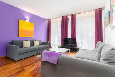 a living room with a couch and a tv at Baron Suites in Valencia